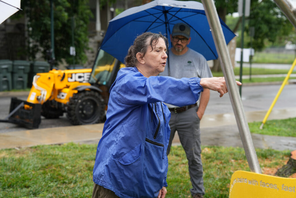 Sculpure Mary Ann Mears directs the final layout of her sculpture "Train of Thought" during the rain.
